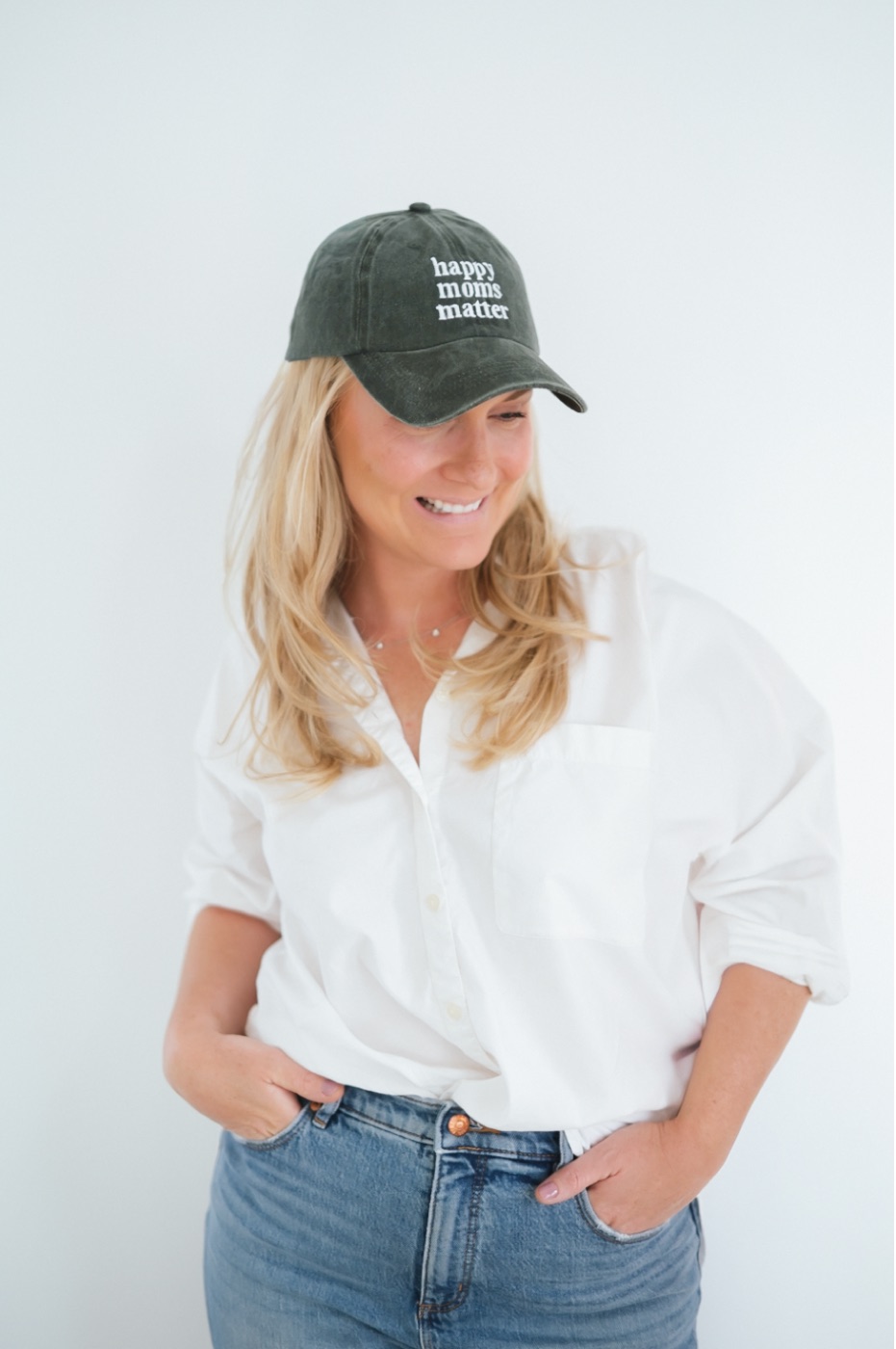 Caitlyn in a cap that reads happy moms matter
