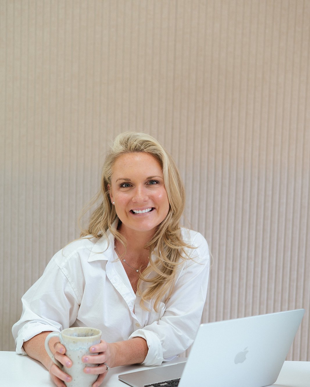 Caitlyn Skolnick at her desk with a mug — parent coaching and strategy sessions in New Jersey