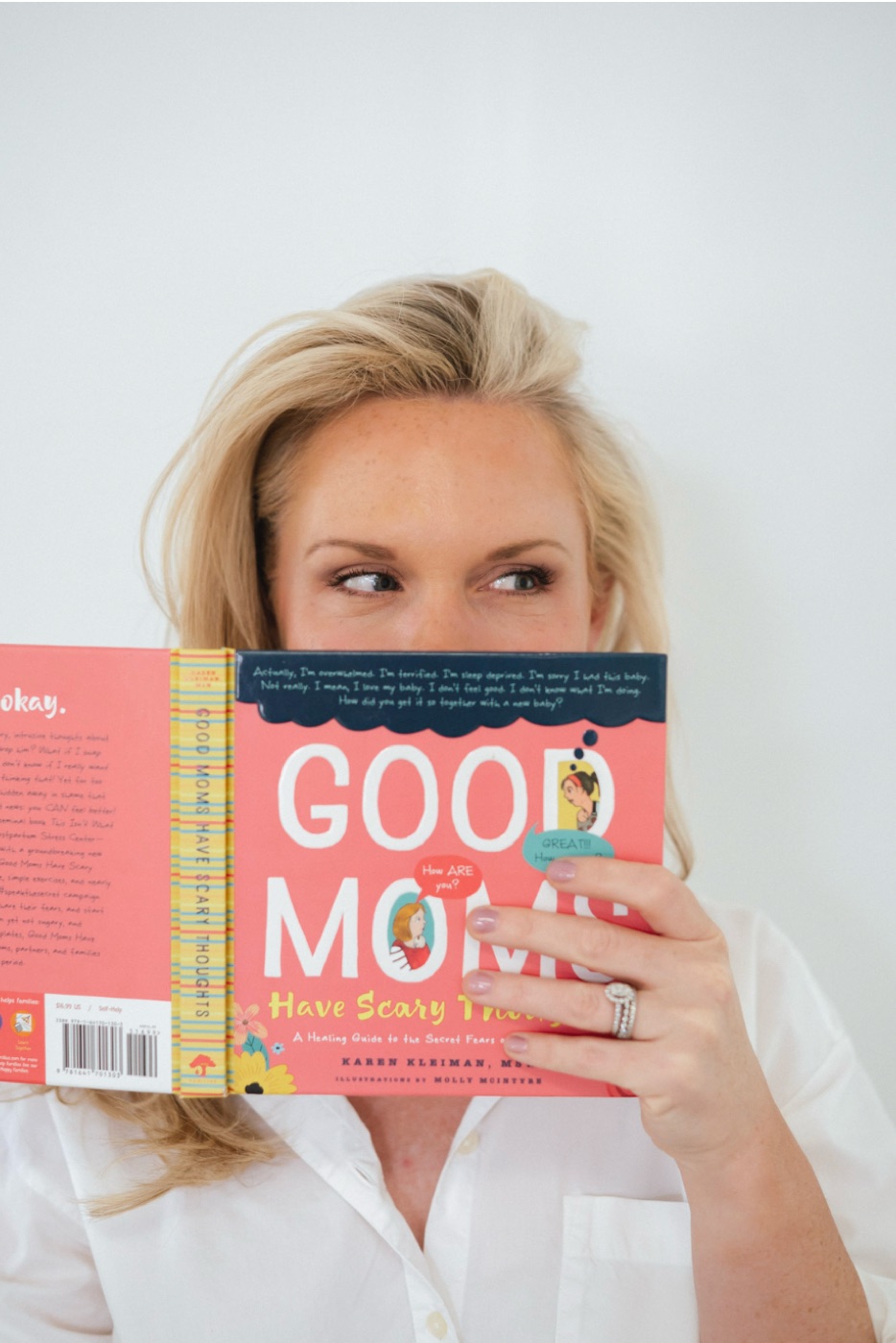 Caitlyn holding the book Good Moms Have Scary Thoughts by Karen Kleiman