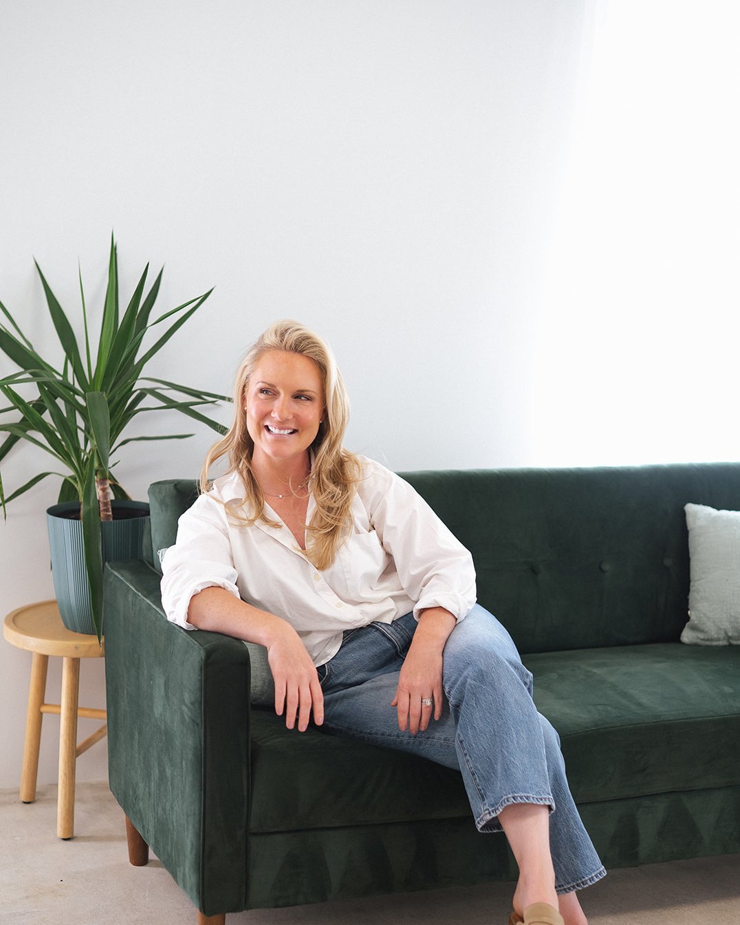 Caitlyn Skolnick seated on the sofa — your couch, my office