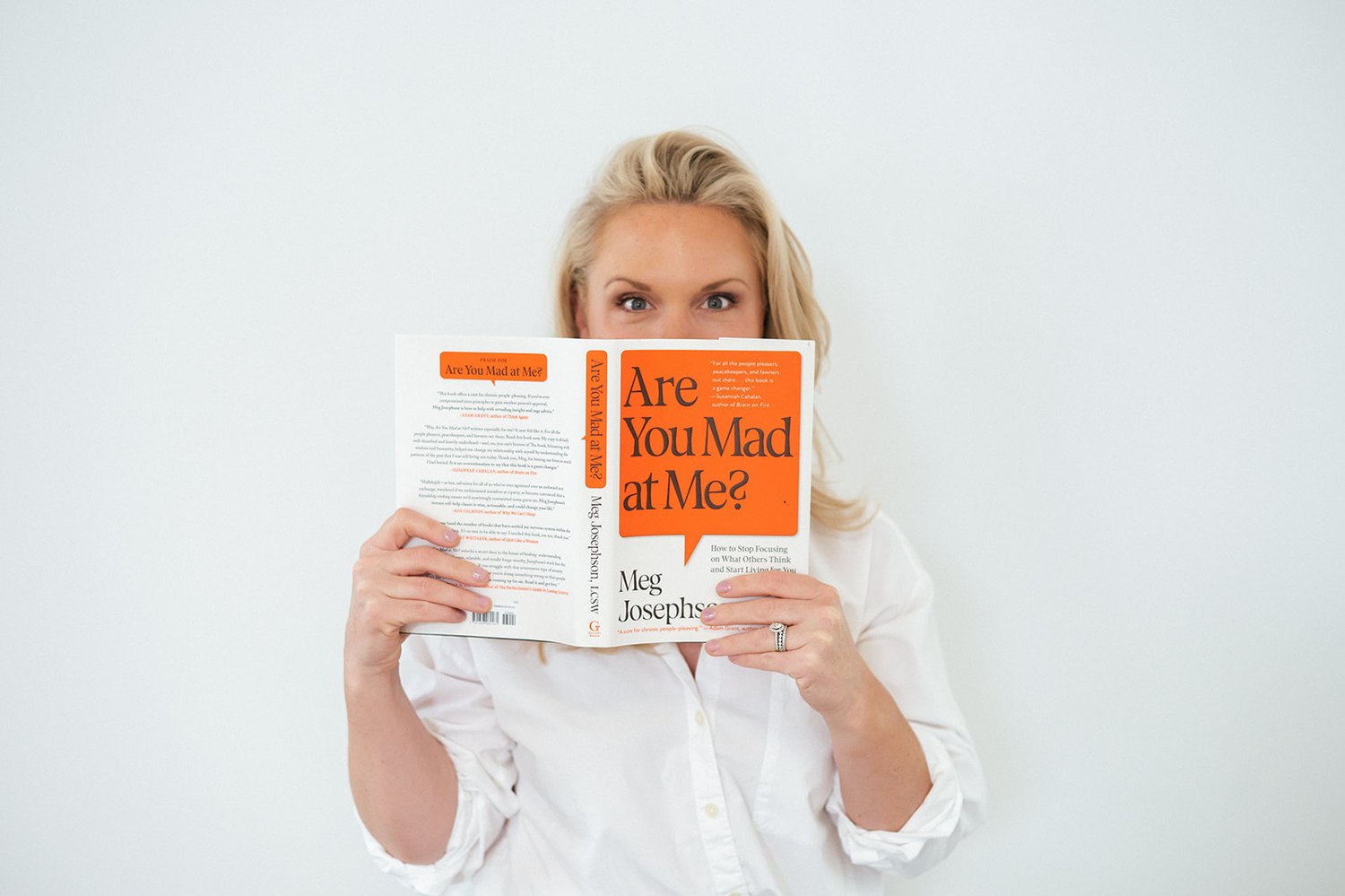 A mother holding a book over her face — the woman you used to know