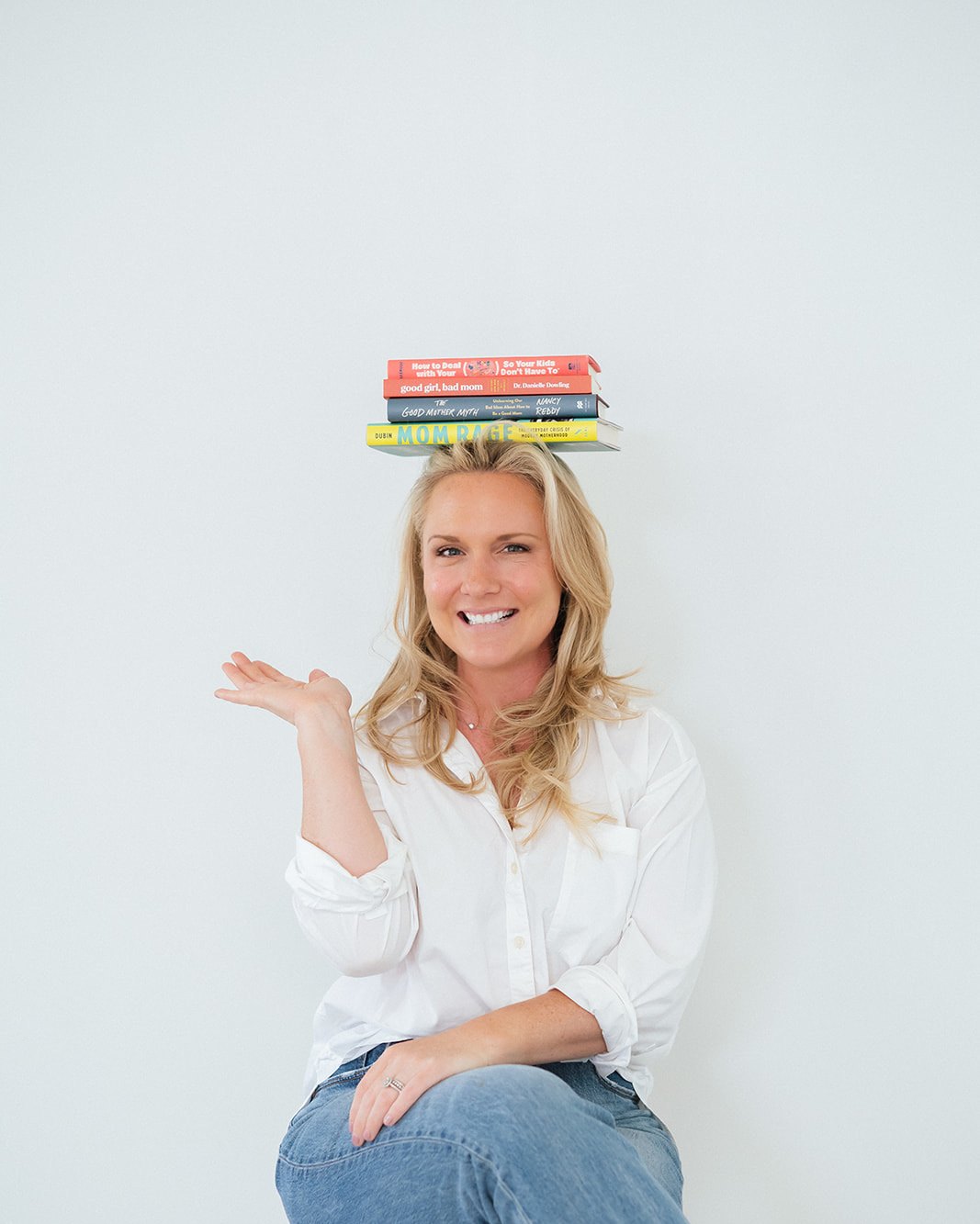 Caitlyn Skolnick balancing parenting books — your house, decoded